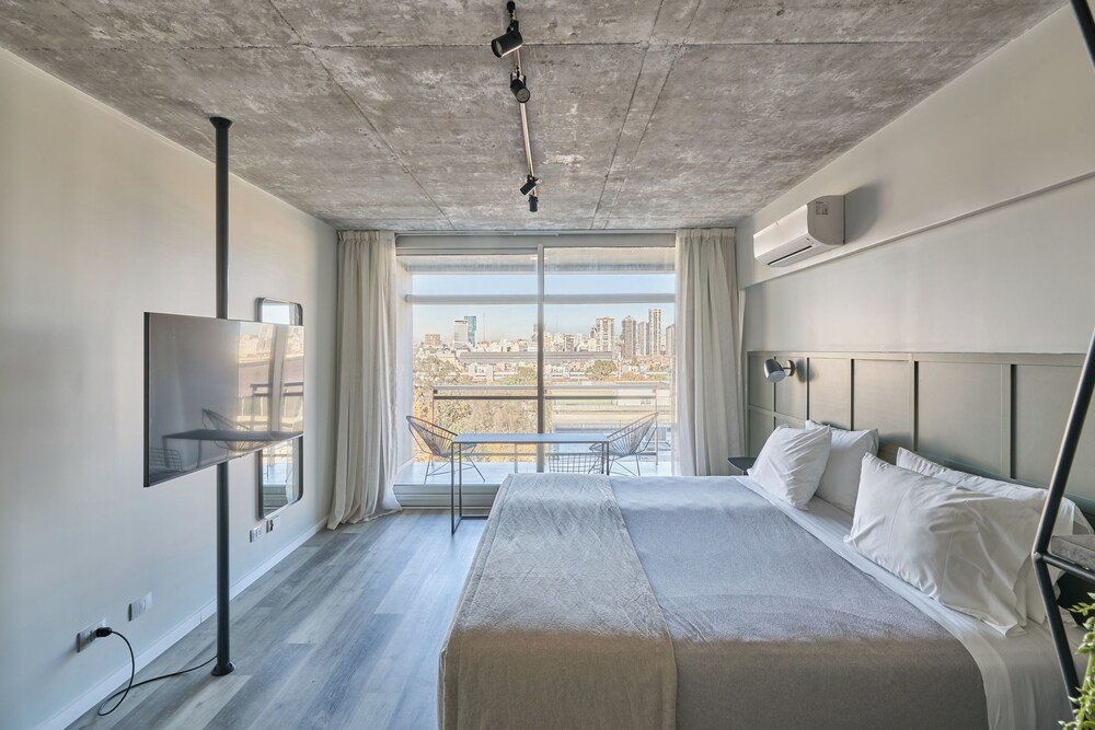 Modern hotel room with a large bed at Almarena Puerto Retiro