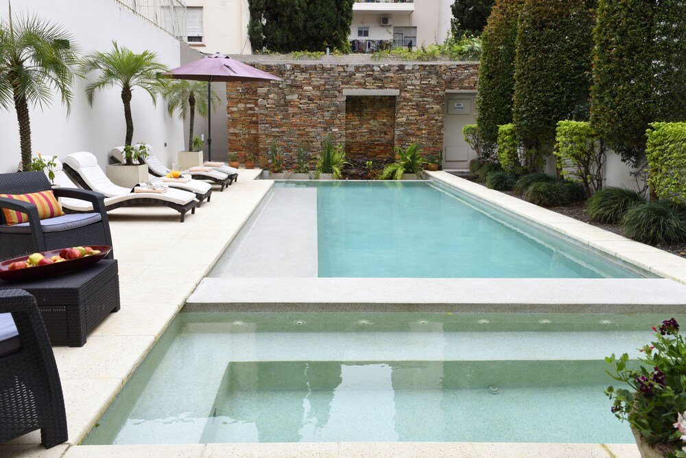 Swimming pool with lounge chairs at Argenta Suites Belgrano