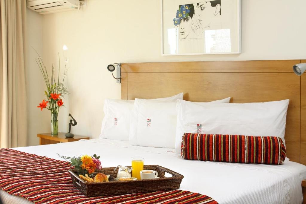 Elegant guest room at BA Sohotel with parquet floor and large bed