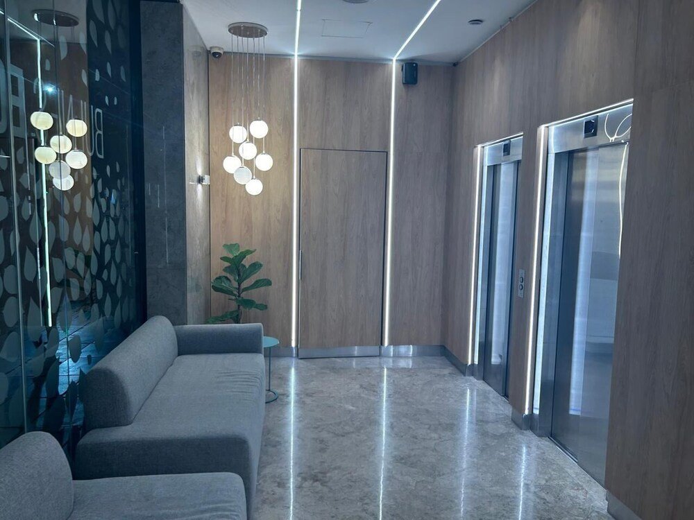 Modern lobby with a sofa and a potted plant