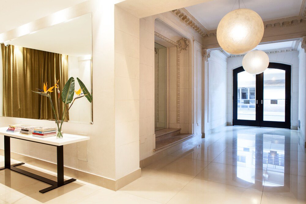 Modern hotel lobby with a white reception desk