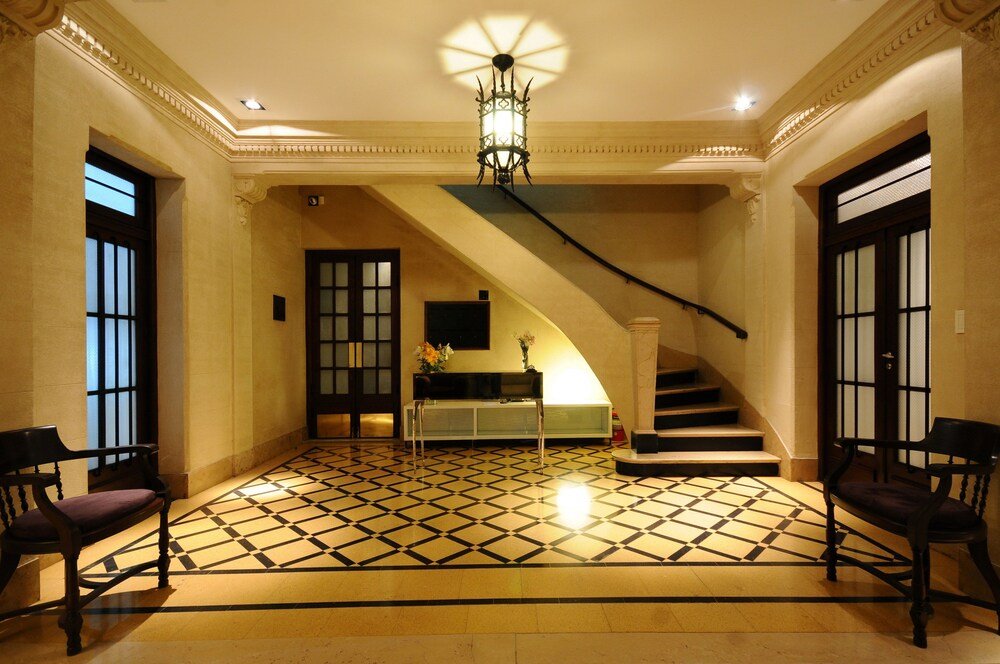 Lobby with a checkered floor and a staircase