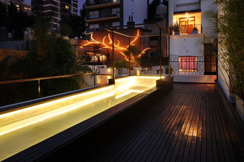 Rooftop pool with a wooden deck