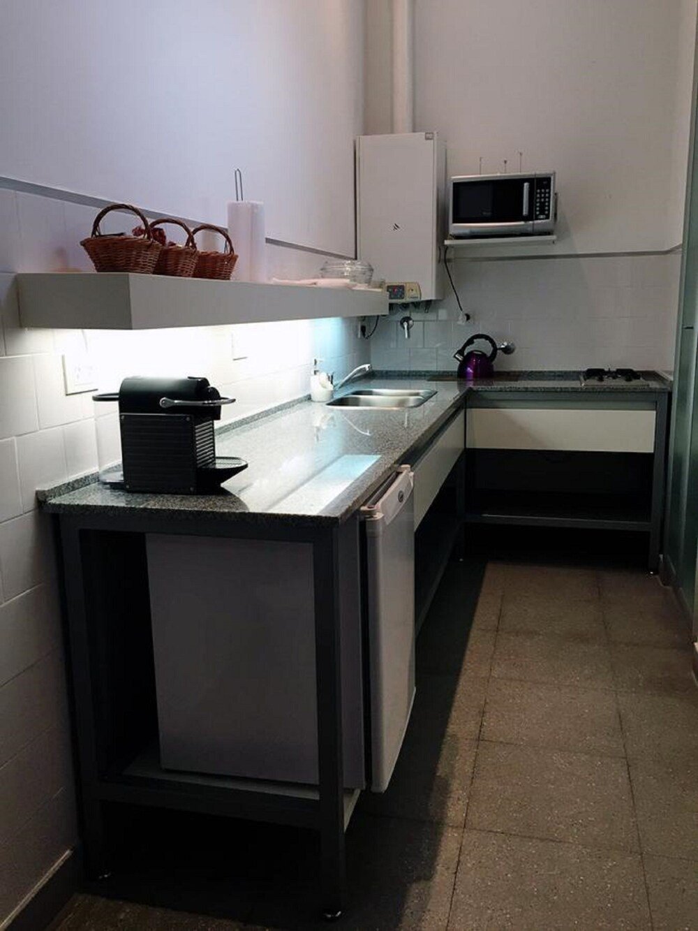 Compact kitchen with a microwave and a sink