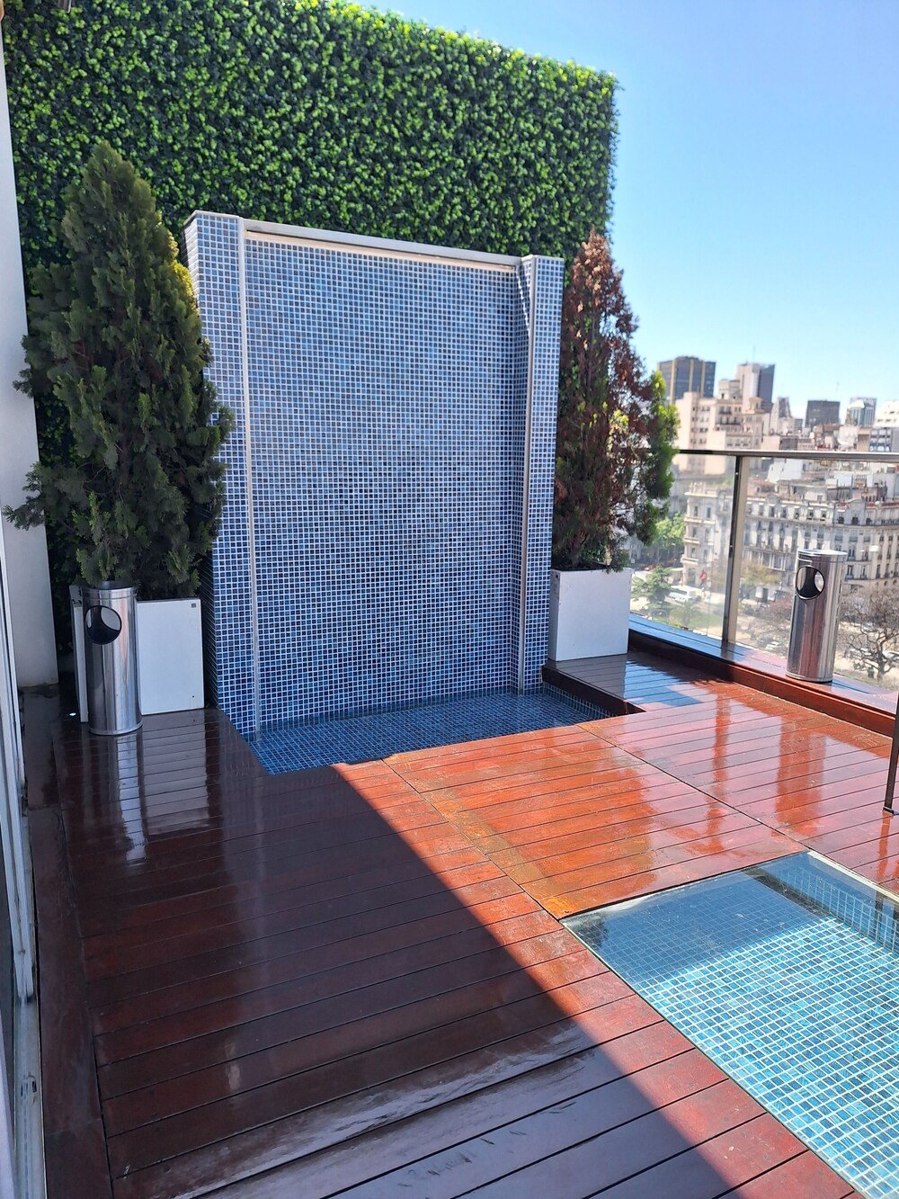 Rooftop terrace with a blue-tiled wall at Eurobuilding Hotel Boutique