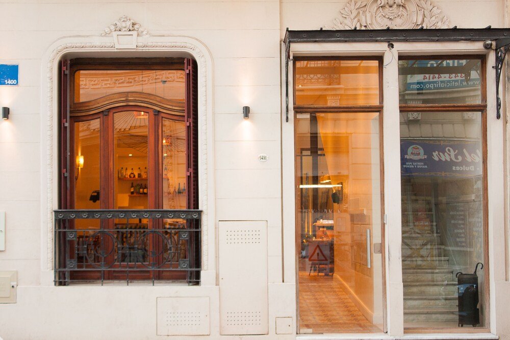 Building facade with a large ornate door at L'Adresse Hôtel Boutique