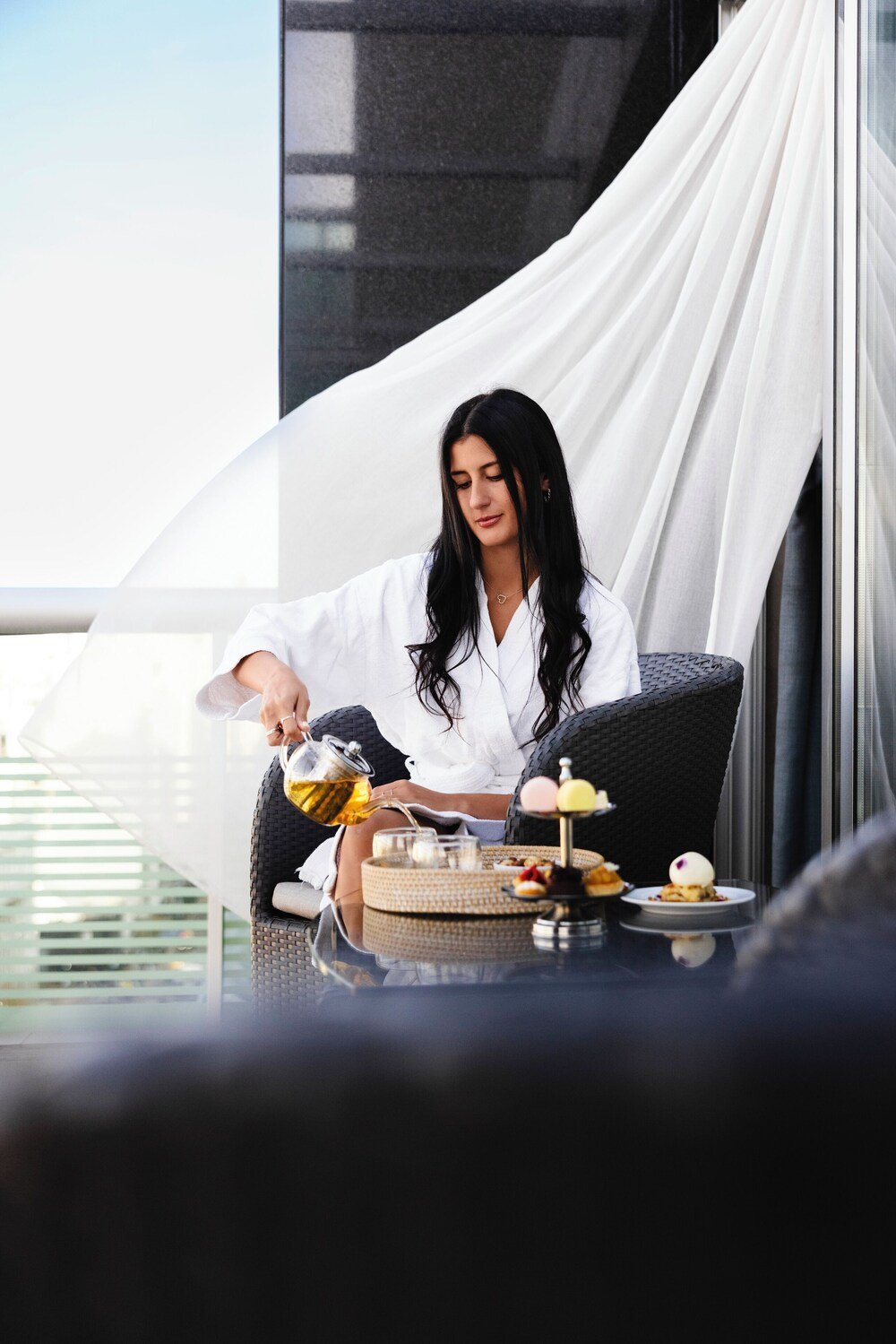 Person seated at a table with a variety of dishes at Palladio Hotel