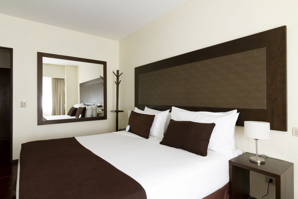 Hotel room with a large bed and neat bedding