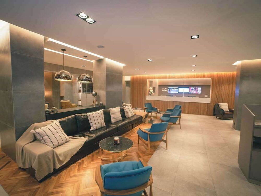 Hotel lobby with a sofa and chairs at Park Royal