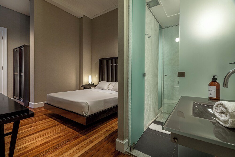 Habitación de hotel moderna con piso de madera y una cama
